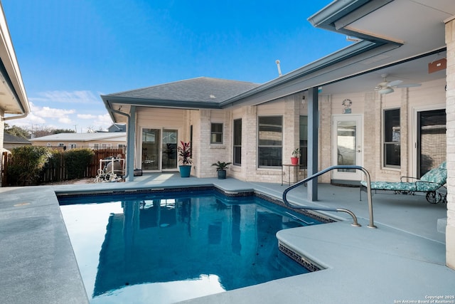 view of swimming pool with ceiling fan and a patio area