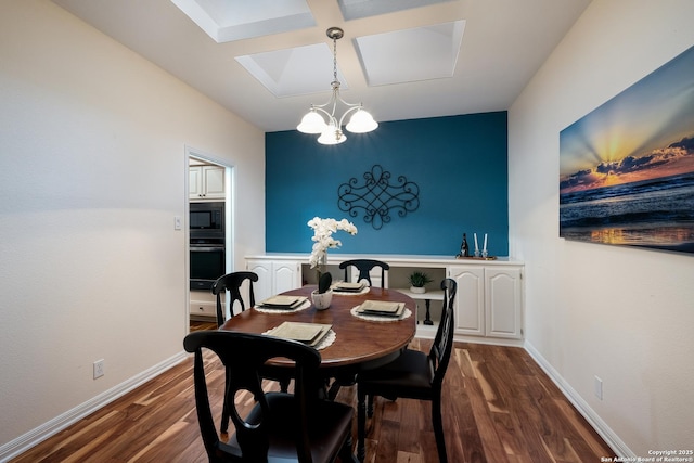 dining room with coffered ceiling, an inviting chandelier, and dark hardwood / wood-style floors