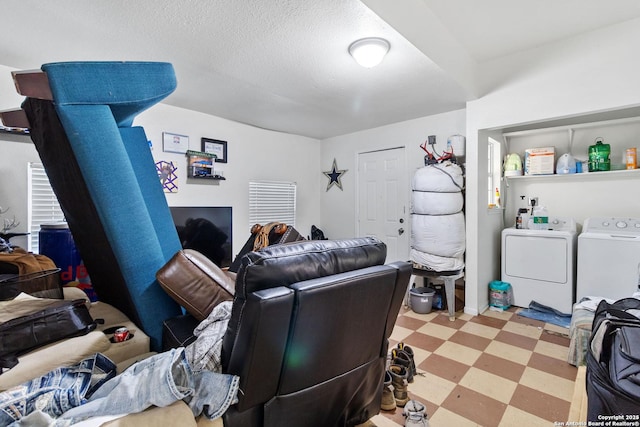 interior space with washer and dryer and a textured ceiling