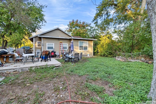 rear view of house with a patio area and a yard