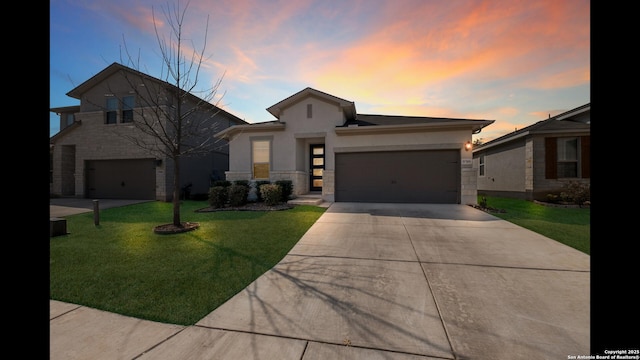 view of front of property featuring a garage and a lawn