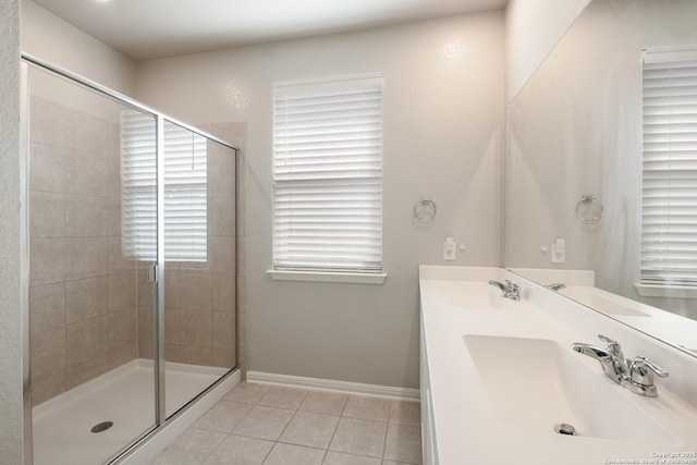 bathroom with an enclosed shower, vanity, and tile patterned floors