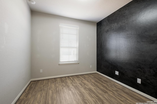 empty room featuring hardwood / wood-style flooring