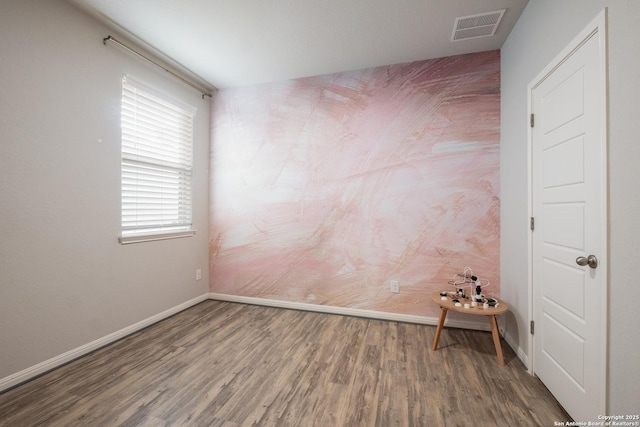 unfurnished room with hardwood / wood-style flooring