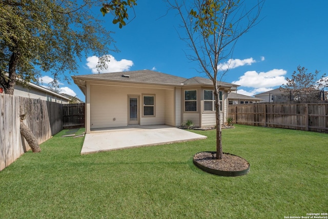 back of property featuring a yard and a patio