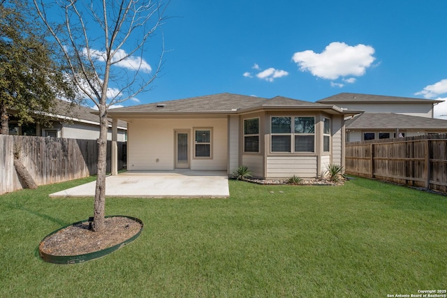 rear view of property with a yard and a patio area