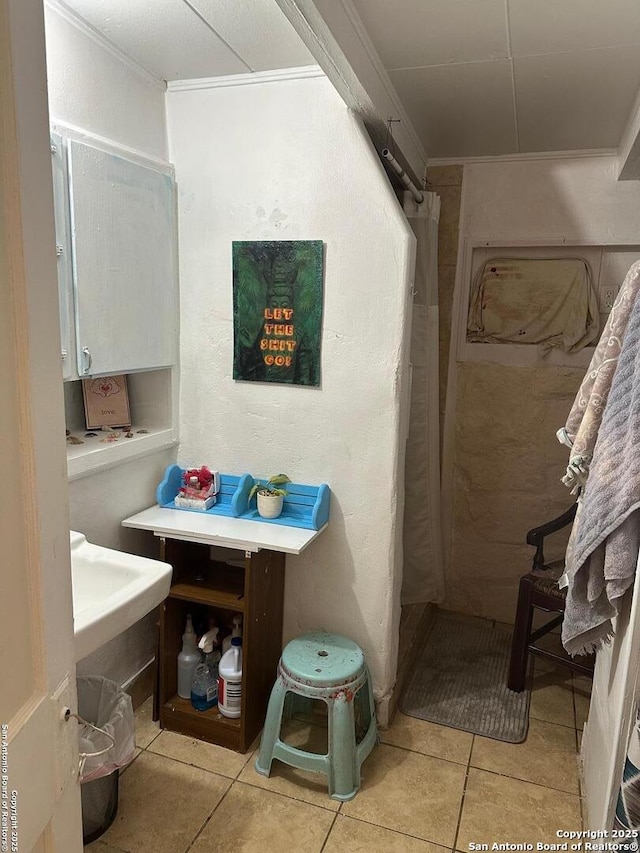 bathroom featuring ornamental molding and tile patterned floors