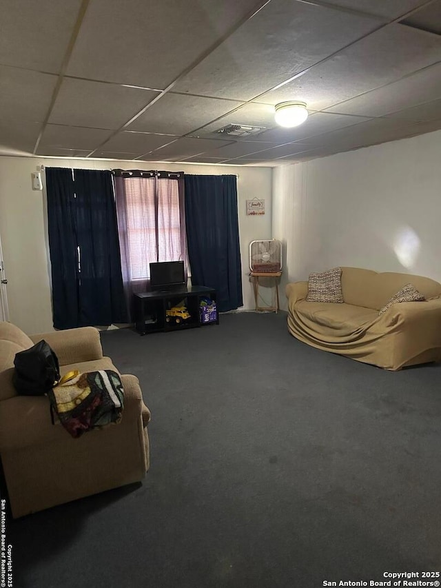 living room with carpet flooring and a drop ceiling