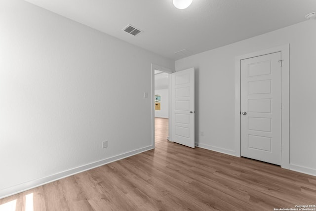 6707 Tasajillo Spgs, San Antonio, TX 78253 - unfurnished bedroom featuring wood finished floors, visible vents, and baseboards