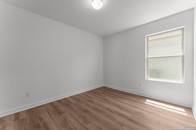 6707 Tasajillo Spgs, San Antonio, TX 78253 - empty room with baseboards and wood finished floors