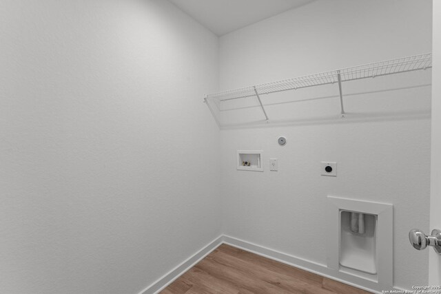 6707 Tasajillo Spgs, San Antonio, TX 78253 - laundry area with baseboards, washer hookup, wood finished floors, electric dryer hookup, and laundry area