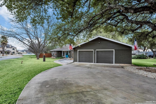 ranch-style house featuring a garage and a front lawn