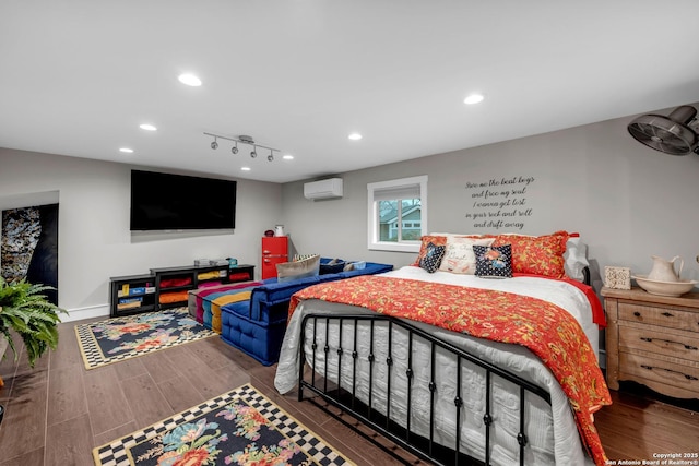 bedroom featuring an AC wall unit and dark hardwood / wood-style floors