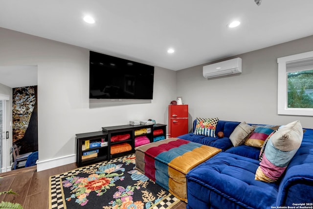 living room with an AC wall unit and hardwood / wood-style floors