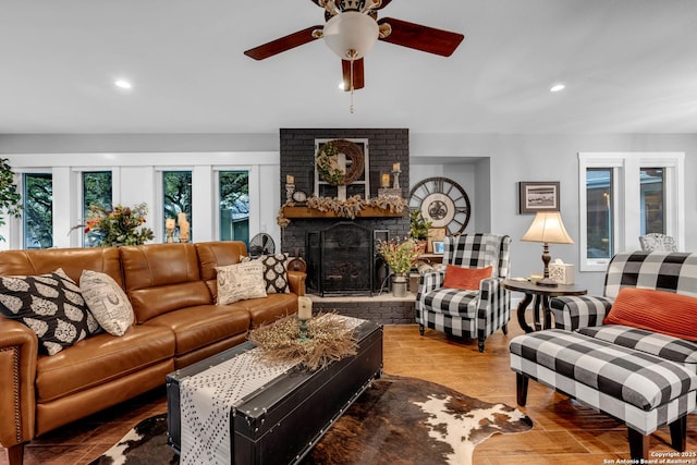 living room featuring a fireplace, ceiling fan, and hardwood / wood-style flooring