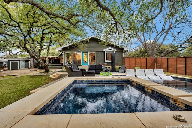 view of swimming pool featuring an outbuilding and an outdoor living space