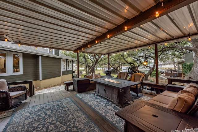 deck with an outdoor living space with a fire pit