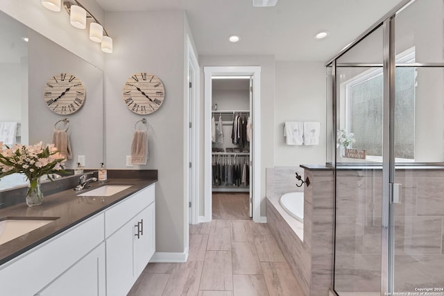 bathroom with vanity and independent shower and bath