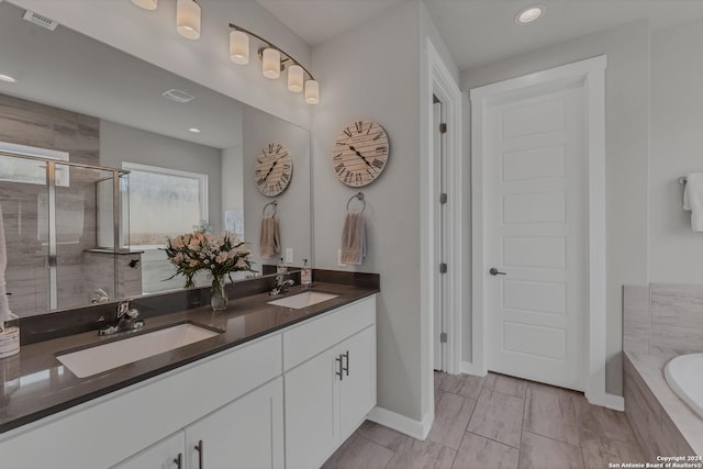 bathroom with plus walk in shower and vanity