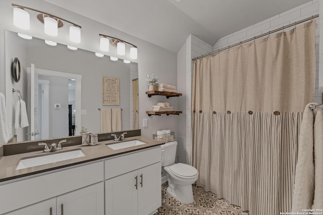 bathroom with vanity, tile patterned flooring, toilet, and walk in shower