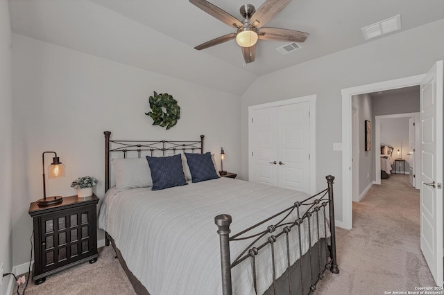 bedroom featuring light carpet, a closet, ceiling fan, and lofted ceiling