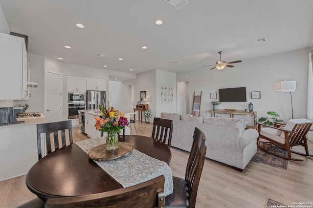 dining space featuring ceiling fan and light hardwood / wood-style floors