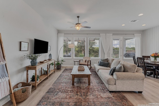 living room featuring light hardwood / wood-style floors and ceiling fan