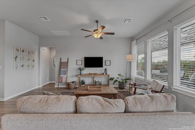 living room featuring ceiling fan and hardwood / wood-style floors