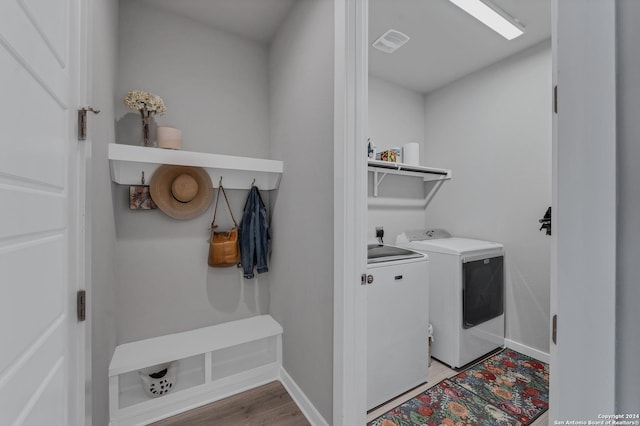 laundry area featuring washer and dryer and hardwood / wood-style flooring