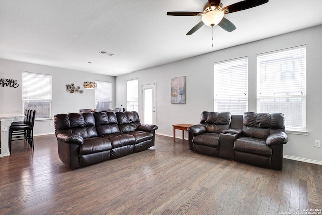 living room with ceiling fan and dark hardwood / wood-style floors