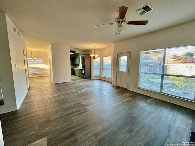 unfurnished living room featuring ceiling fan with notable chandelier and hardwood / wood-style floors