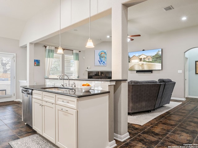 kitchen featuring white cabinetry, sink, vaulted ceiling, dishwasher, and pendant lighting