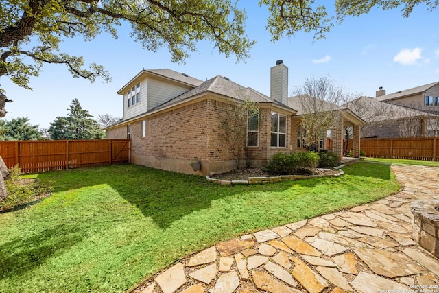 back of house featuring a lawn and a patio