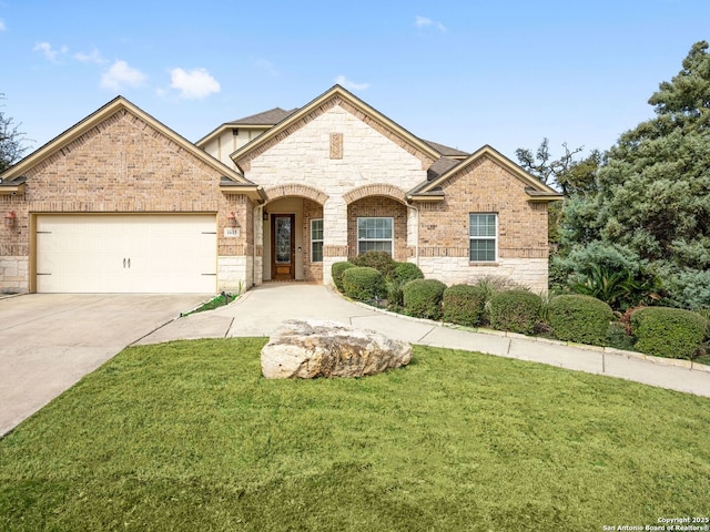 view of front of property with a front yard and a garage