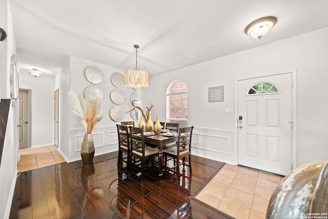 dining area featuring a notable chandelier and hardwood / wood-style flooring