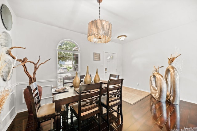 dining area featuring a notable chandelier and dark hardwood / wood-style floors