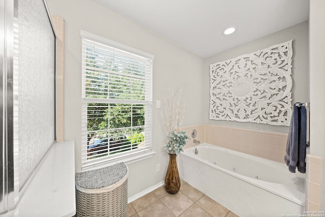 bathroom featuring a tub to relax in and tile patterned flooring