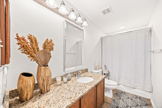 bathroom featuring vanity, toilet, and tile patterned floors