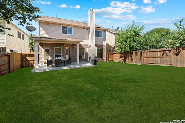 back of house featuring a yard and a patio area