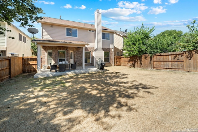 rear view of house featuring a patio