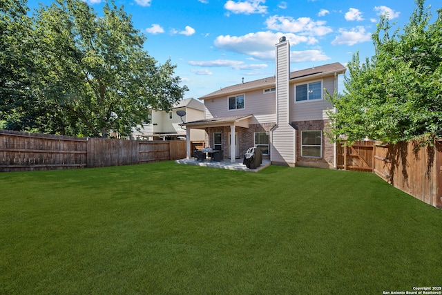 back of property with a patio and a lawn