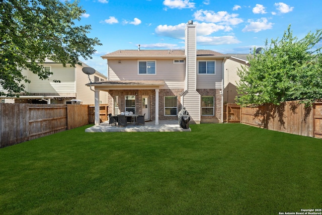 back of property with a patio and a lawn