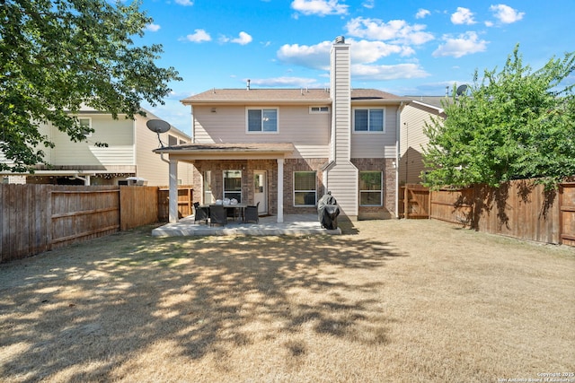 back of house with a patio