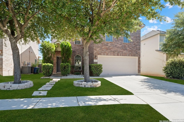 view of front of house featuring a front yard, a garage, and cooling unit