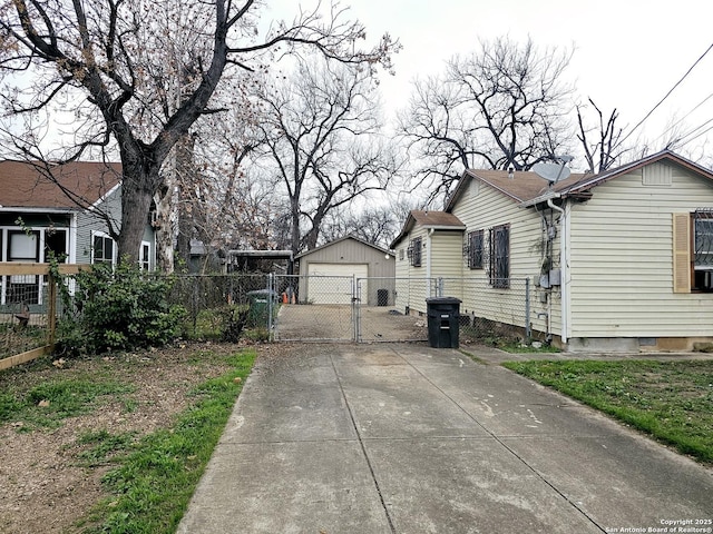 view of home's exterior with a garage and an outbuilding