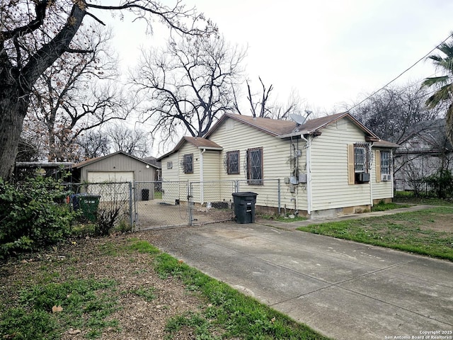 view of side of property with a garage, cooling unit, and an outdoor structure