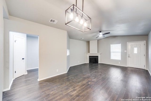 unfurnished living room featuring ceiling fan, dark wood-type flooring, and vaulted ceiling