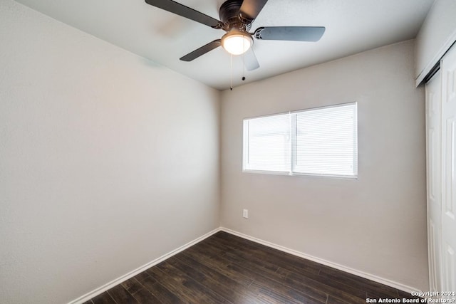 spare room with ceiling fan and dark hardwood / wood-style flooring