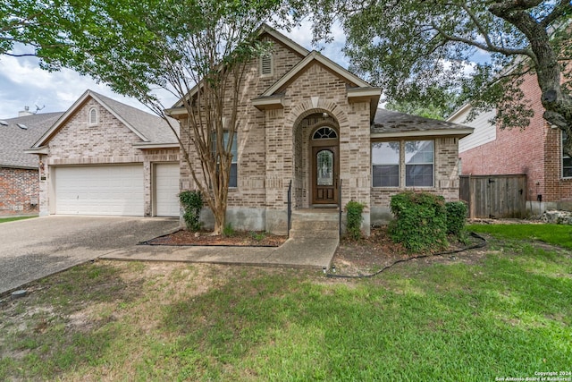 view of front of home with a garage and a front yard