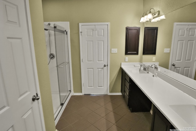 bathroom with tile patterned floors, a shower with shower door, and vanity